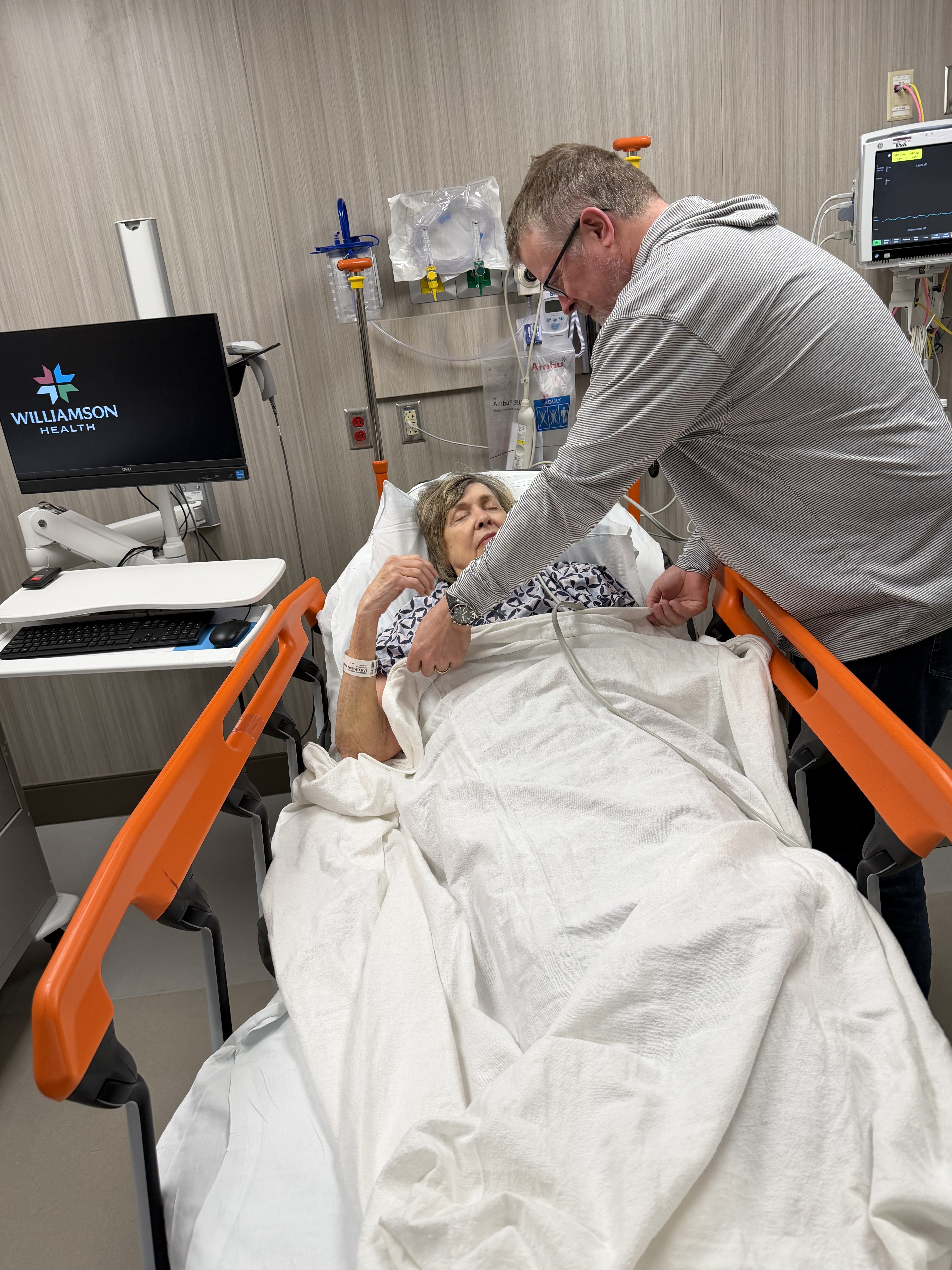 A family member comforting another in the emergency room
