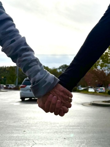A grandmother and grandchild holding hands