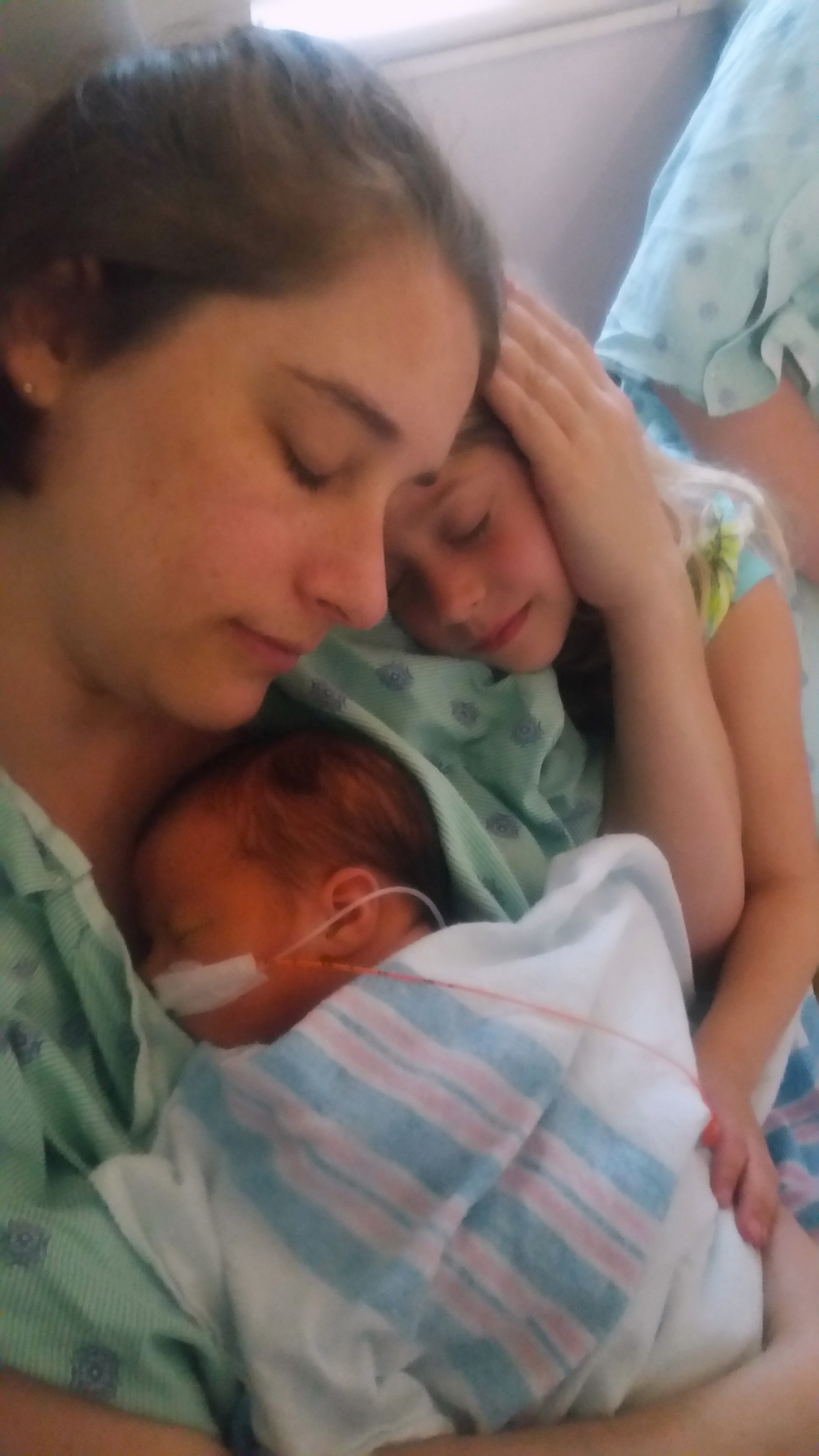 A family bonding with their newborn in the NICU